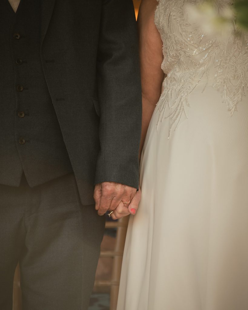 Holding hands at a Loughborough wedding